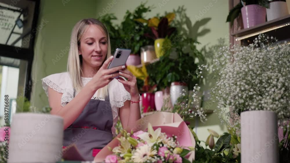 Florist Entrepreneur Using Smartphone For Photographing Plants At Her Flower Shop. Photographing Plants For Social Media Florist Entrepreneur Using Smartphone For Photographing Plants At Her Flower Shop. Photographing Plants For Social Media