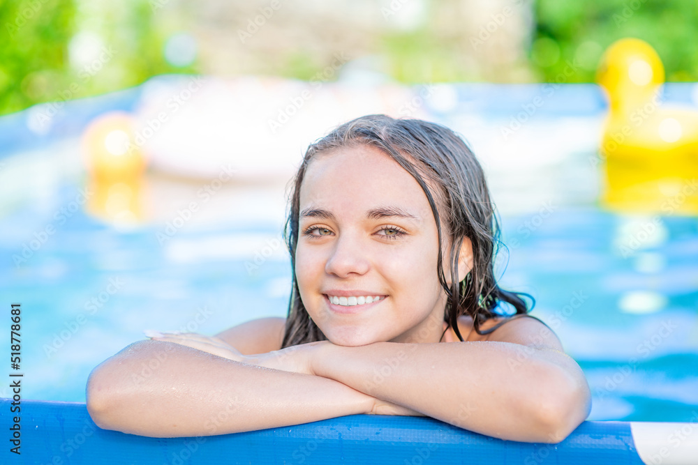 Smiling teen girl enjoing in the pool at sunny day Smiling teen girl enjoing in the pool at sunny day