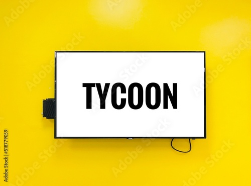  tycoon note on television against yellow wall