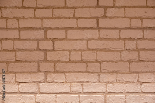A pale orange brick wall neatly arranged in a horizontal manner