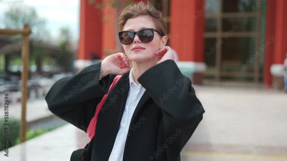 Cute businesswoman having conversation on smartphone outdoors. portrait of beautiful caucasian female business person who talking on cell phone dressed black coat standing city street Cute businesswoman having conversation on smartphone outdoors. portrait of beautiful caucasian female business person who talking on cell phone dressed black coat standing city street