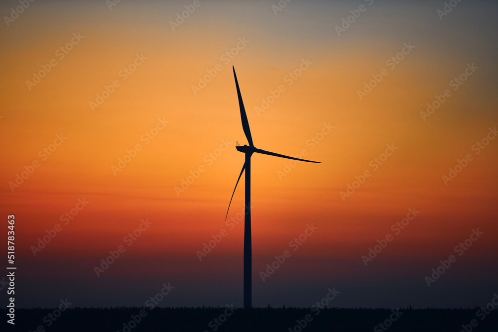 Obraz premium Windmill farm park in silhouettes with colorful sky.