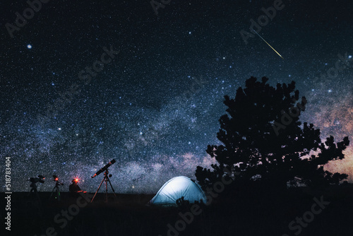 Fototapet Amateur astronomer with astronomical telescope camping in nature under the Milky way stars