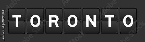 Black color analog flip board with word toronto on gray background
