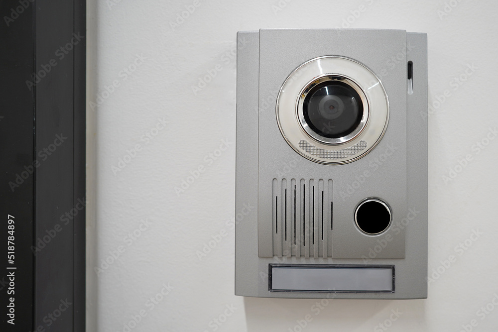 Video intercom system on white wall to enter office. Intercum with a camera in the office. New video intercom. Video intercom display on white wall near the entrance door Video intercom system on white wall to enter office. Intercum with a camera in the office. New video intercom. Video intercom display on white wall near the entrance door
