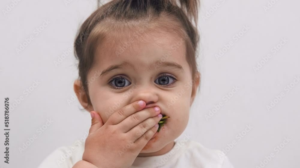 Close-up of the face of a child eating strawberries. High quality. Cute little girl. Close-up of the face of a child eating strawberries. High quality. Cute little girl.