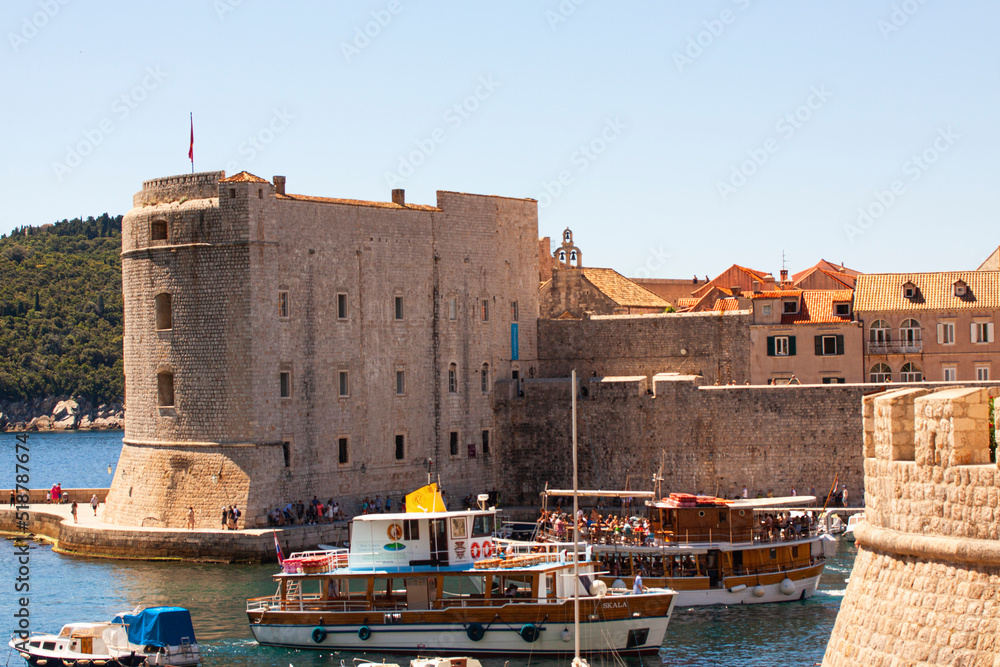 View over the harbor in the historic city center of Dubrovnik, Croatia with part of the fortress and surrounding city walls.
