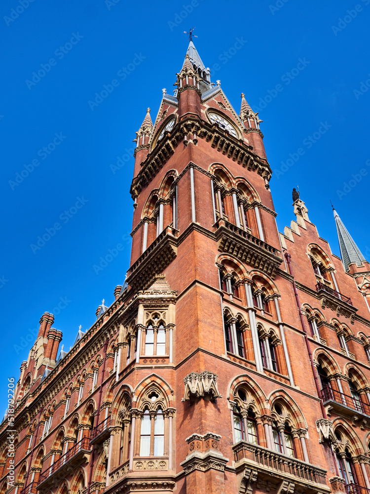 Building exterior of St. Pancras International Railway Station, with a clock tower. London, England, UK