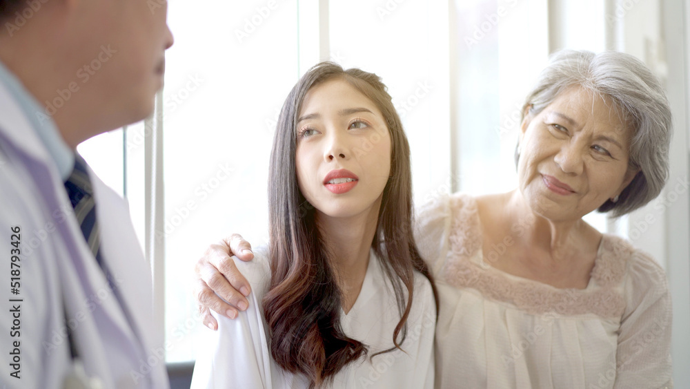 Asian young woman and her mother talking to doctor for the health advise. Asian young woman and her mother talking to doctor for the health advise.