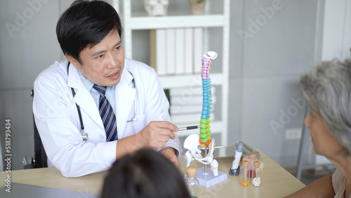 Asian young woman and her mother taking to doctor at hospital about orthopedic disease. 