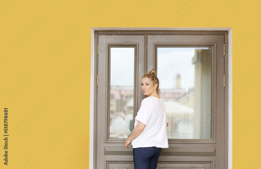 Beautiful woman opening the door of her home. Beautiful woman opening the door of her home.
