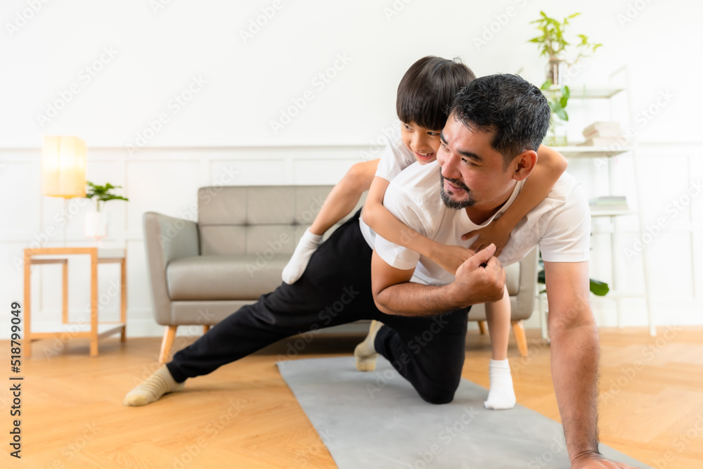 Young asian parents with child meditating at home isolated in room. Family, sport, yoga concept. Young asian parents with child meditating at home isolated in room. Family, sport, yoga concept.