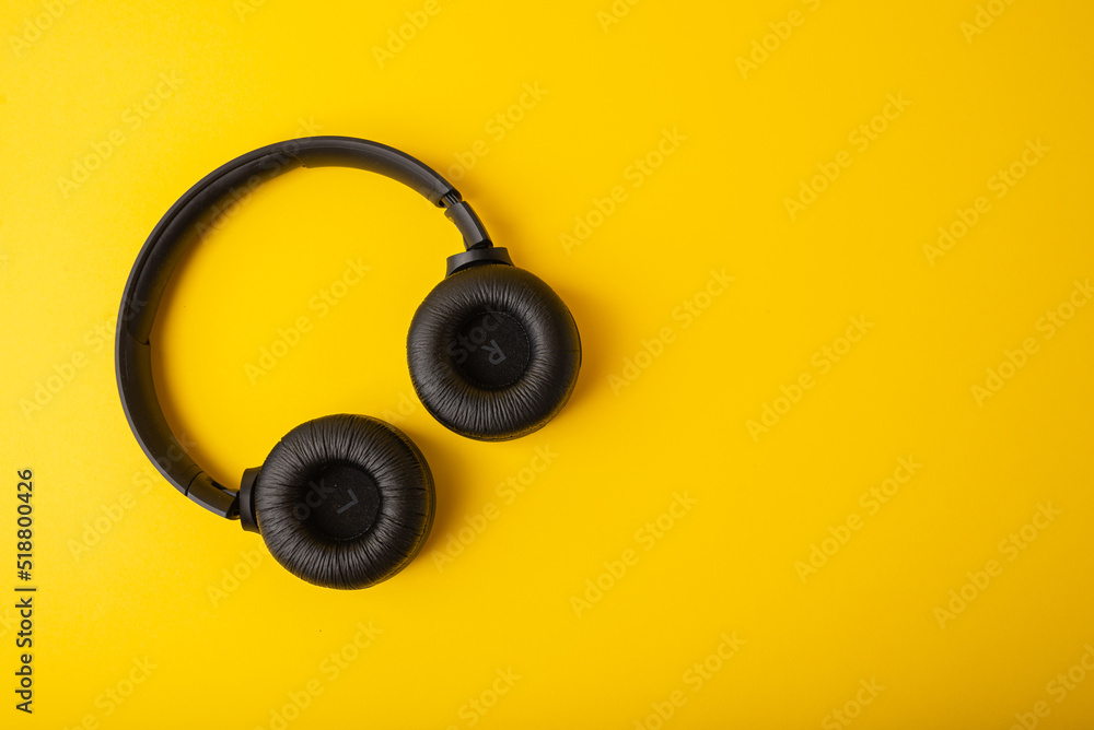 Wireless headphones with embroideries on a yellow background Wireless headphones with embroideries on a yellow background