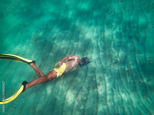 underwater man snorkeling in the sea withcrystal-clear waters concept of holiday relax summer beach diver in the sea	