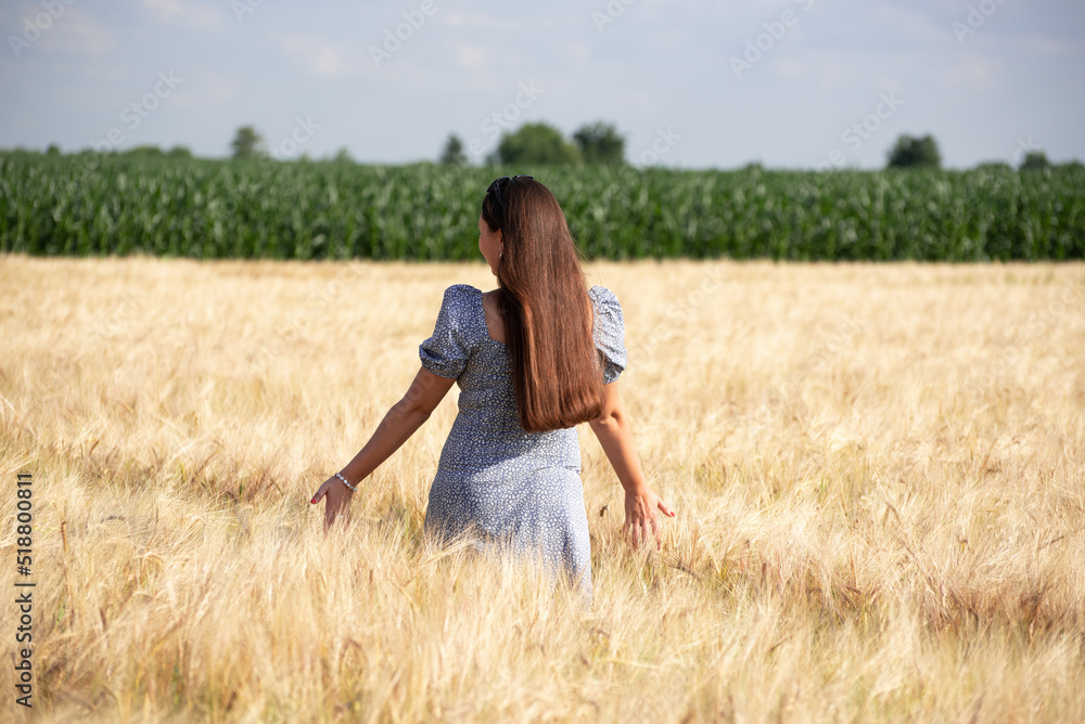 Portrait of happy girl in wheat field, nature of Ukraine. Growing grains for agricultural aims.Summer time Portrait of happy girl in wheat field, nature of Ukraine. Growing grains for agricultural aims.Summer time