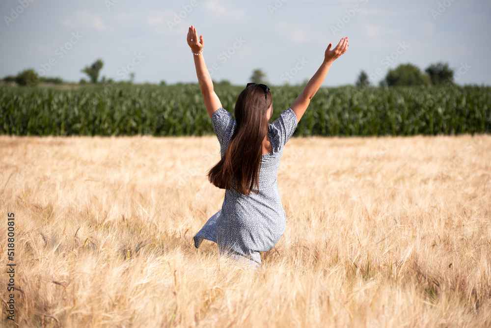 Portrait of happy girl in wheat field, nature of Ukraine. Growing grains for agricultural aims.Summer time Portrait of happy girl in wheat field, nature of Ukraine. Growing grains for agricultural aims.Summer time