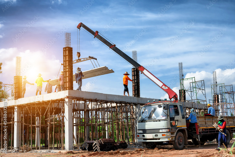 Cranes are lifting concrete slabs on the second floor in the construction of a warehouse building. Cranes are lifting concrete slabs on the second floor in the construction of a warehouse building.