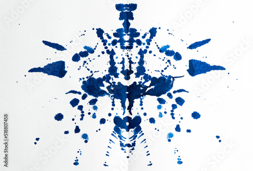 Rorschach test used in Psychoanalysis. Blue, symmetric, mirror images made of granulated ink on white background