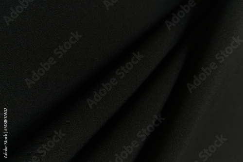 Foto Black crumpled or wavy fabric texture background
