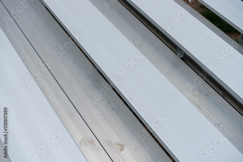 abstract background (aluminum, bleacher benches) at a sports field