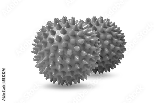 Two gray spiny massage balls isolated on white. Concept of physiotherapy or fitness. Closeup of a colorful rubber ball for dog teeth on a white color background. Corona virus model.