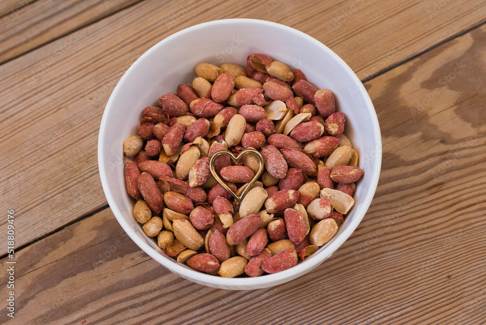 salted peanuts on wooden table. salted peanuts on wooden table.