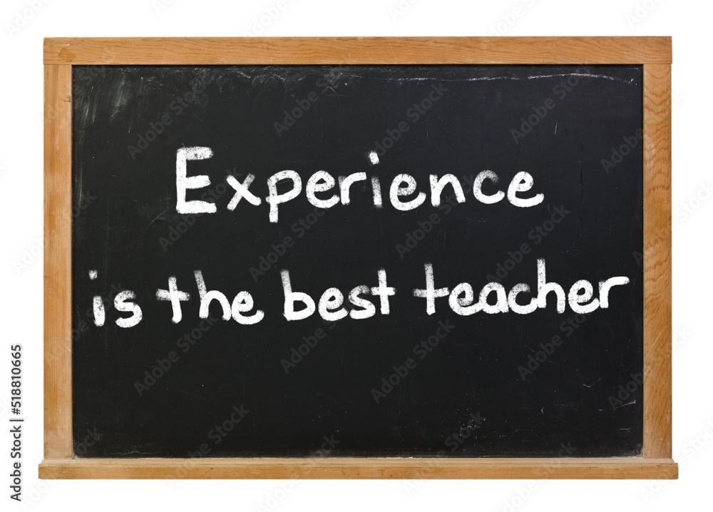 Experience is the best teacher written in white chalk on a black chalkboard isolated on white Experience is the best teacher written in white chalk on a black chalkboard isolated on white