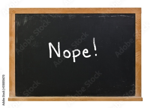 Nope written in white chalk on a black chalkboard isolated on white