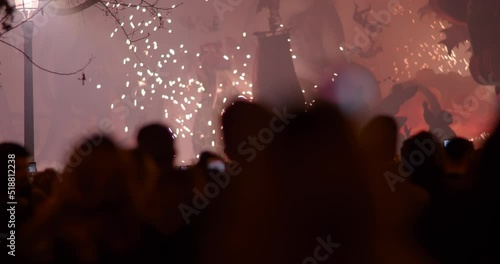 People celebrating Fallas festival and looking at ninot fireworks, Spain