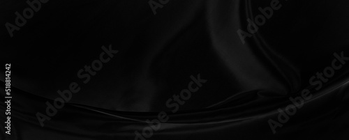 Black gray satin dark fabric texture luxurious shiny that is abstract silk cloth panorama background with patterns soft waves blur beautiful.