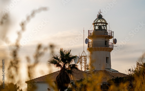 Cullera's lighthouse at dawn, on a clear and sunny day photo