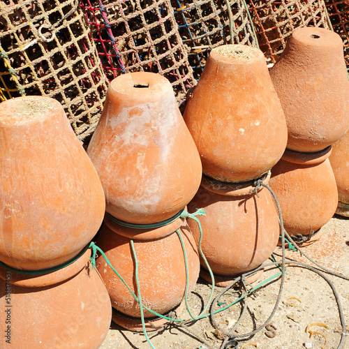 Ceramic pots (pulperas) and plastic mesh traps for octopus fishing in the fishing port of Rota, Cadiz coast, Spain photo