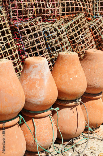 Ceramic pots (pulperas) and plastic mesh traps for octopus fishing in the fishing port of Rota, Cadiz coast, Spain photo