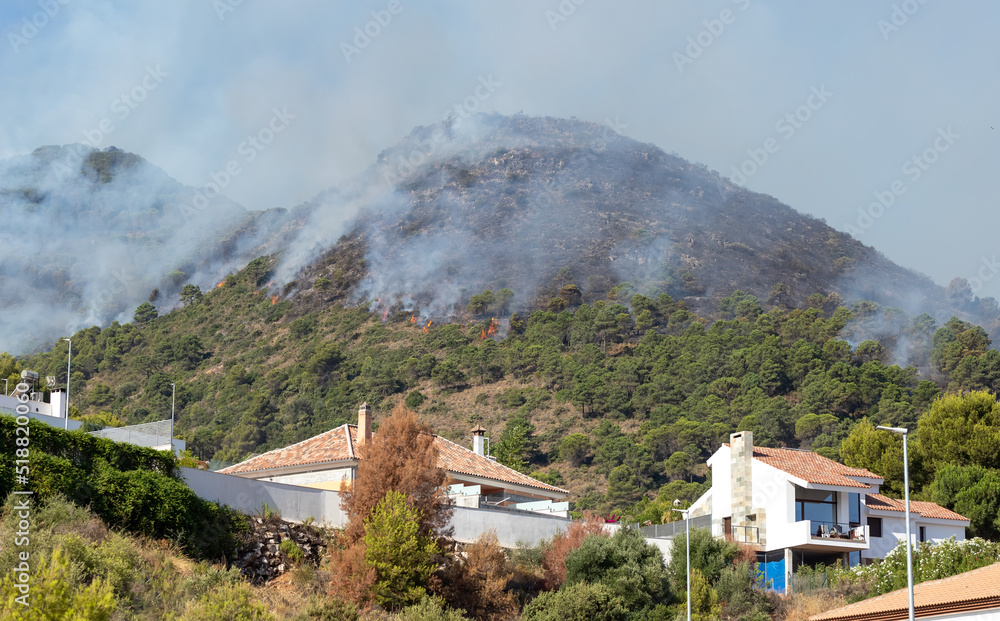 Fire dangerously approaching homes in Pinos de Alhaurín. Forest fire in the Sierra de Mijas in Malaga, Spain.. Fire dangerously approaching homes in Pinos de Alhaurín. Forest fire in the Sierra de Mijas in Malaga, Spain..