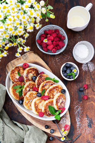 Syrniki (cottege cheese pancakes) with berries and sauce