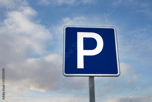 Parking road sign against the blue sky
