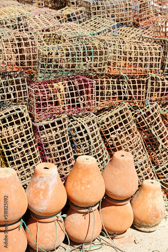 Pulperas de cerámica y nasas de malla de plástico para la pesca del pulpo en el puerto pesquero de Rota, costa de Cádiz, España photo