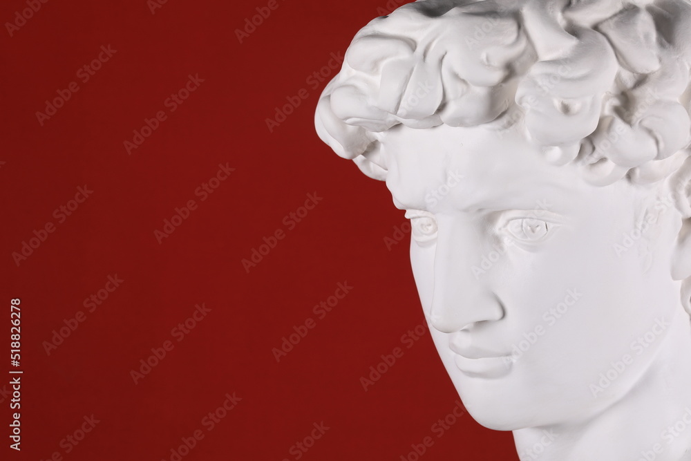 ancient white plaster head sculpture on a red background ancient white plaster head sculpture on a red background