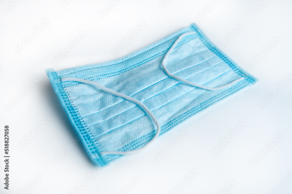 blue medical mask close-up on a white background blue medical mask close-up on a white background