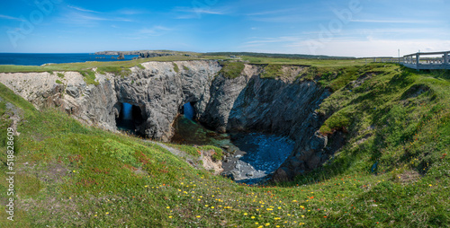 Rock formations carved by the mighty Atlantic Ocean over many years are seen in Dungeon Provincial Park near Cape Bonavista, Newfoundland on a sunny day.