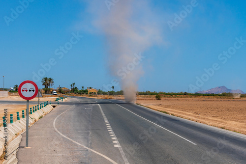 Dust devil created by high ground temperatures crossing a highway, Cartagena.