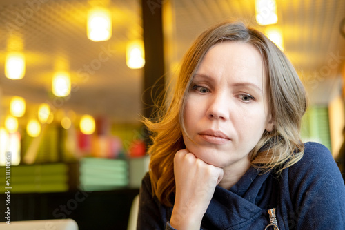 Sad adult woman in a cafe. Depression, crisis.