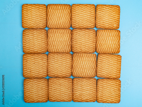 Many square shortbread cookies are stacked in rows. Can be used as a background.
