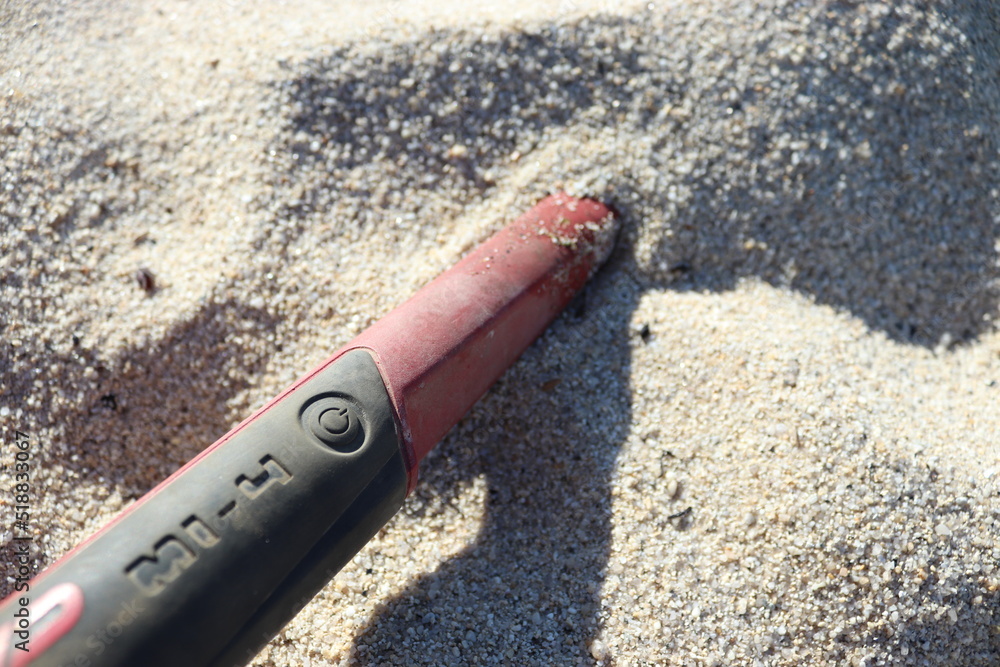 pinpointer in a hand at the beach on the sand Stock Photo Adobe Stock