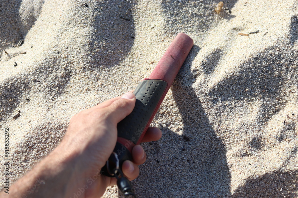 pinpointer in a hand at the beach on the sand Stock Photo Adobe Stock