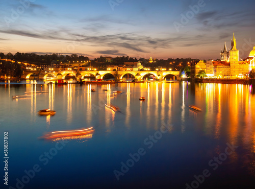 Prague, Czech Republic - June 2022: View with the Charles Bridge main touristic attraction at sunset. Medieval stone arch bridge over Vltava river in Prague