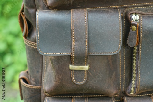 part of a leather brown trendy backpack with durable fittings and closed pockets