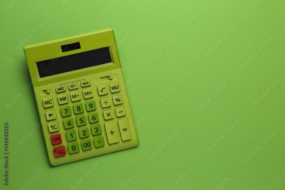 Modern calculator on green background, top view. Space for text Modern calculator on green background, top view. Space for text