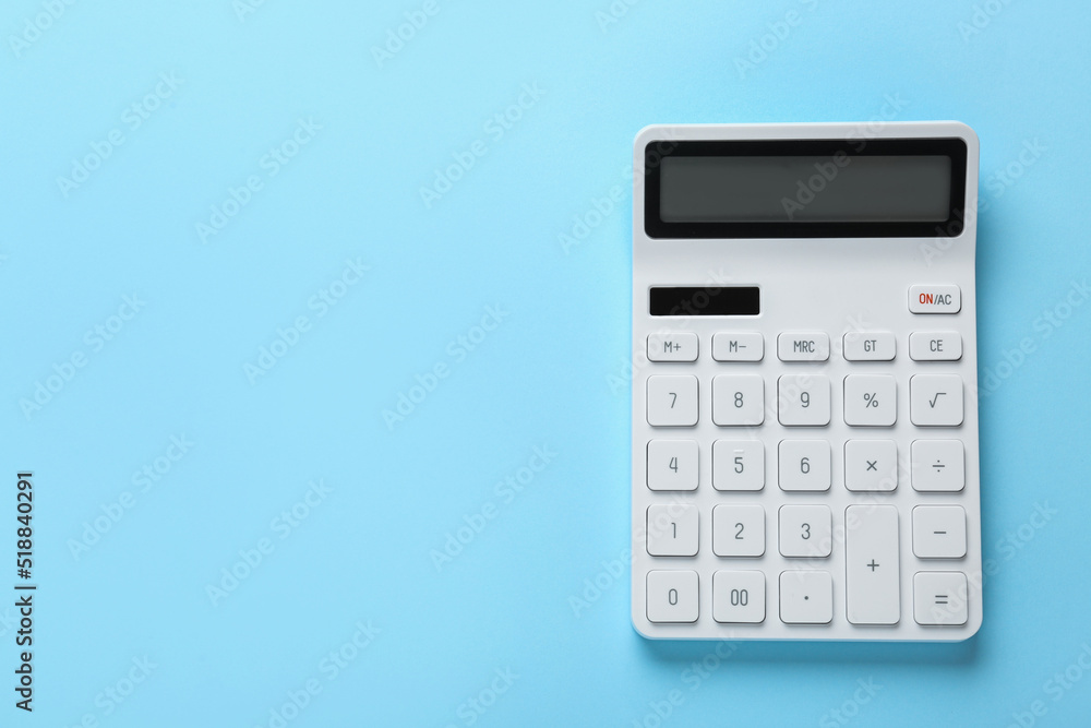White calculator on light blue background, top view. Space for text White calculator on light blue background, top view. Space for text