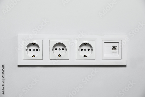 Power sockets on white wall. Electrical supply